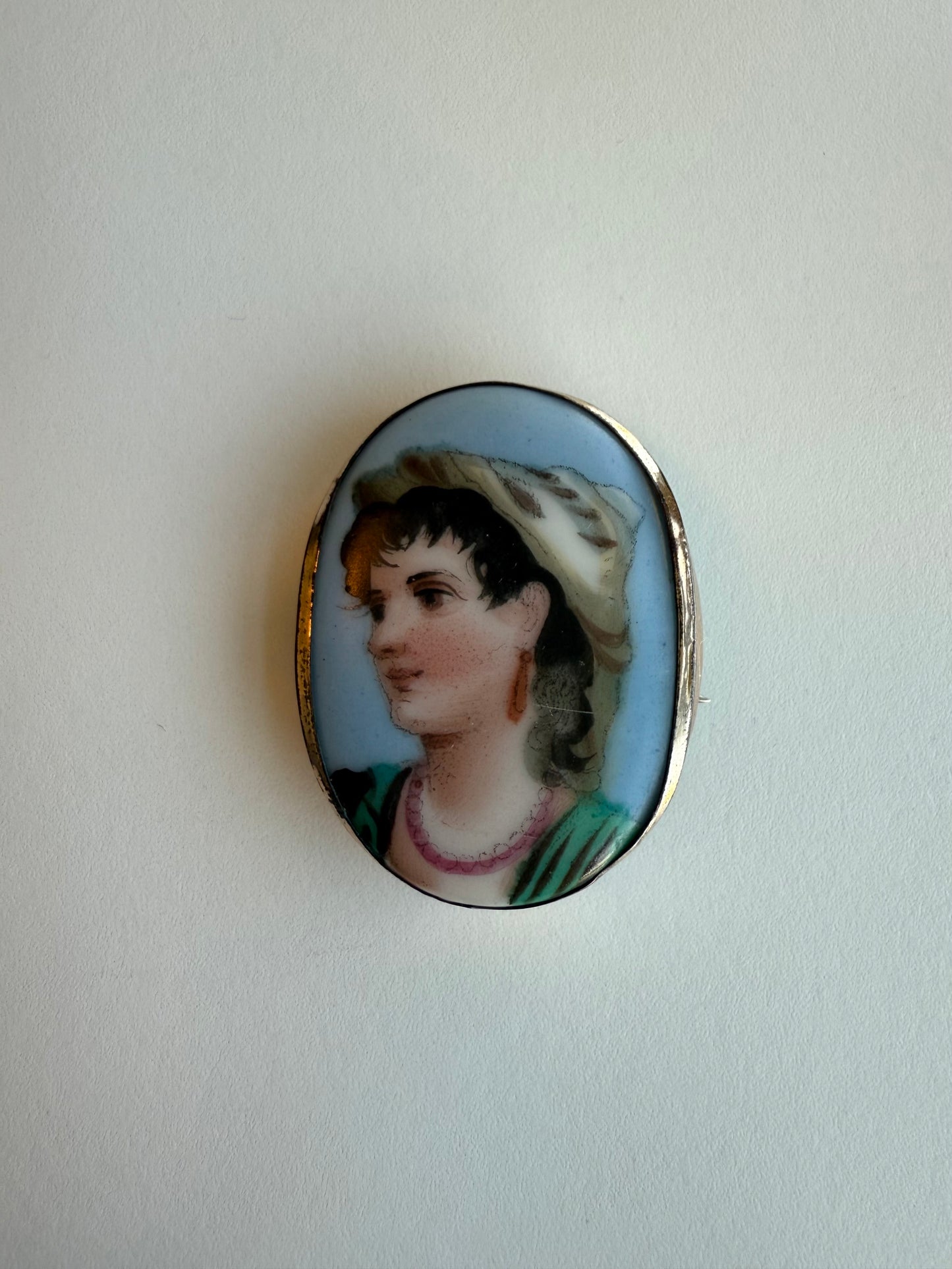 Cameo brooch with a portrait of a woman on a white background