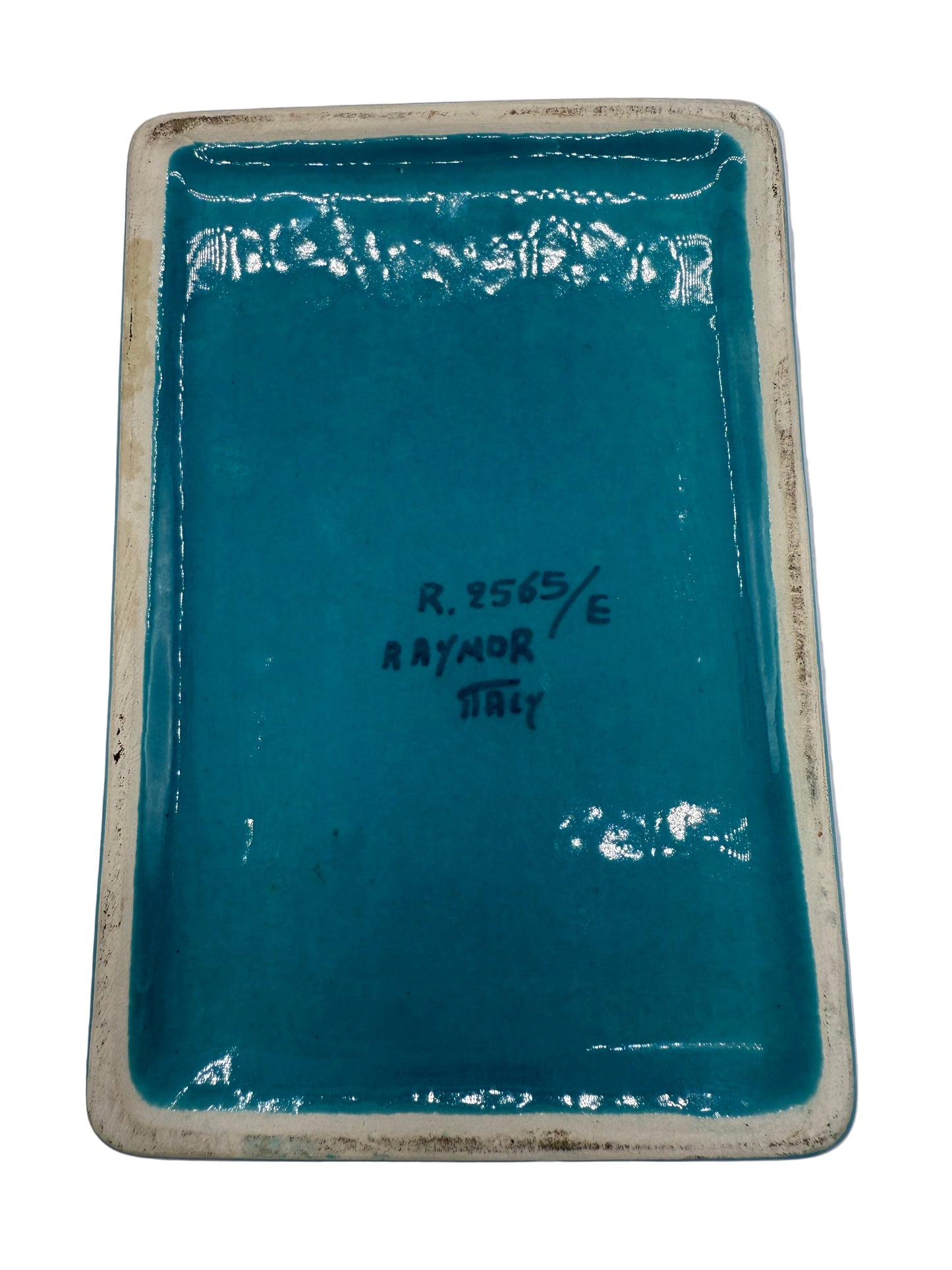 Rectangular blue ceramic dish with white rim on a gray background