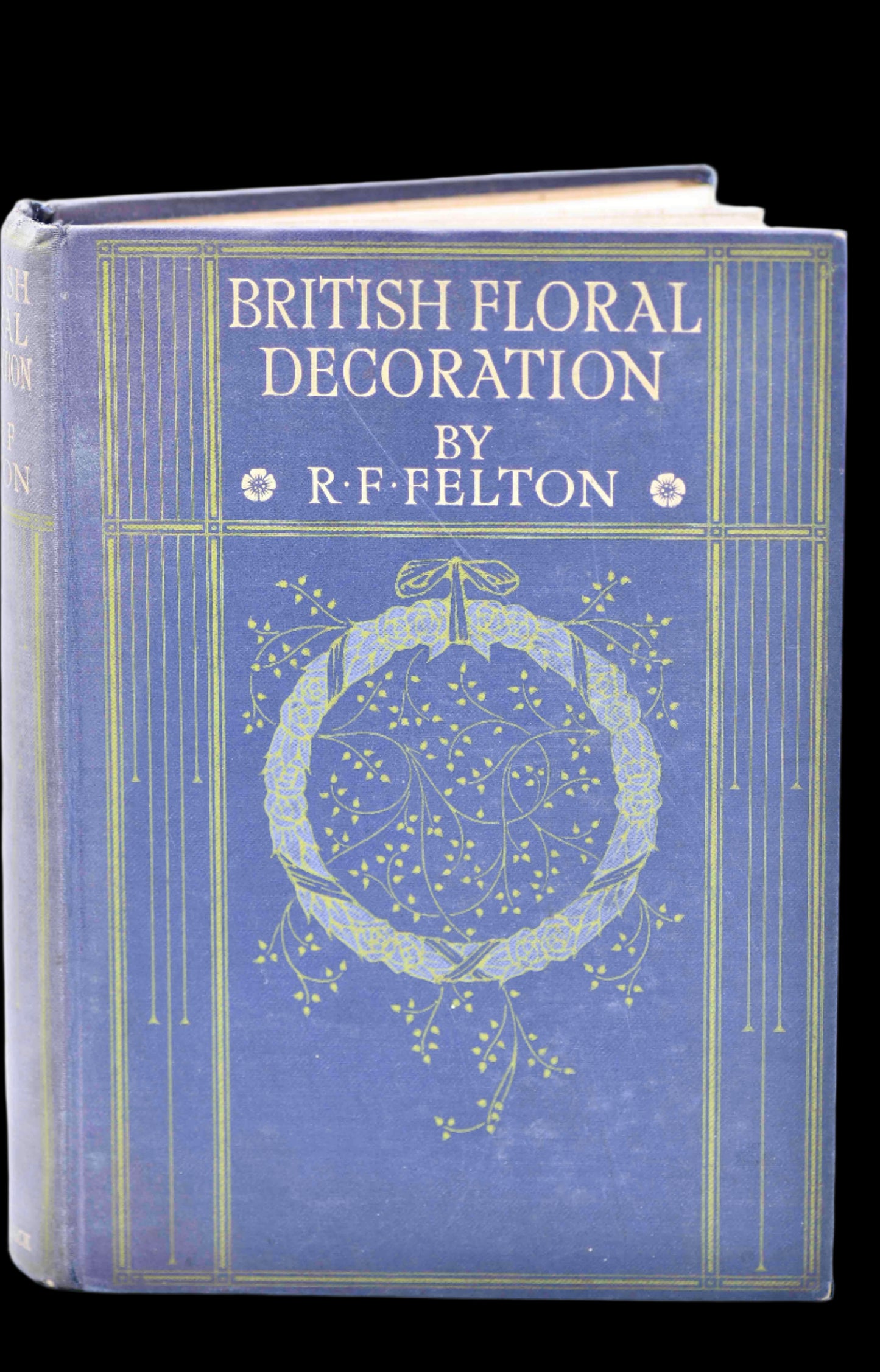A hardcover book with a dark purple and blue cover featuring a decorative floral design and the title 'BRITISH FLORAL DECORATION' by R. FELTON.