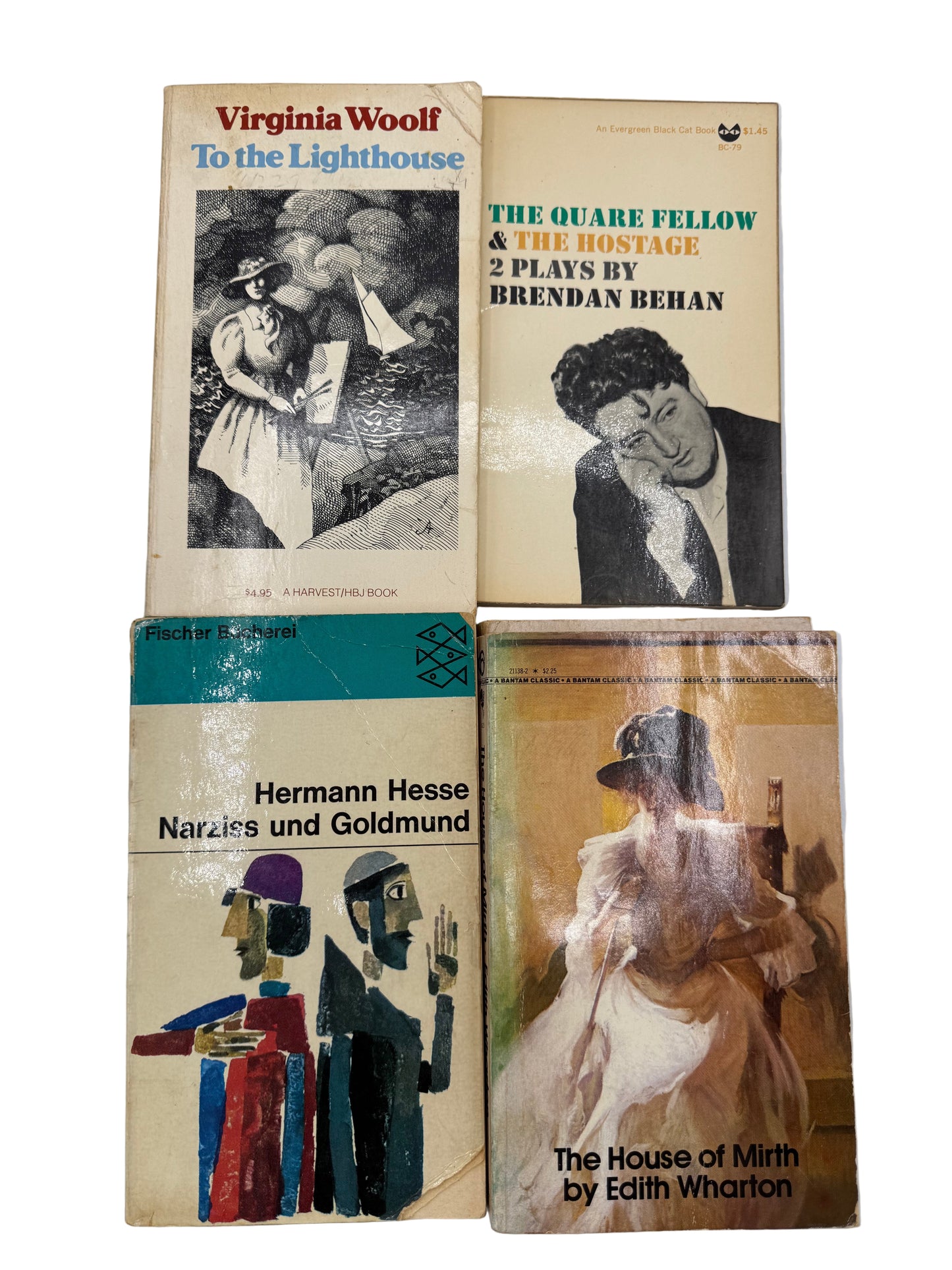 Four vintage books stacked on a light gray background