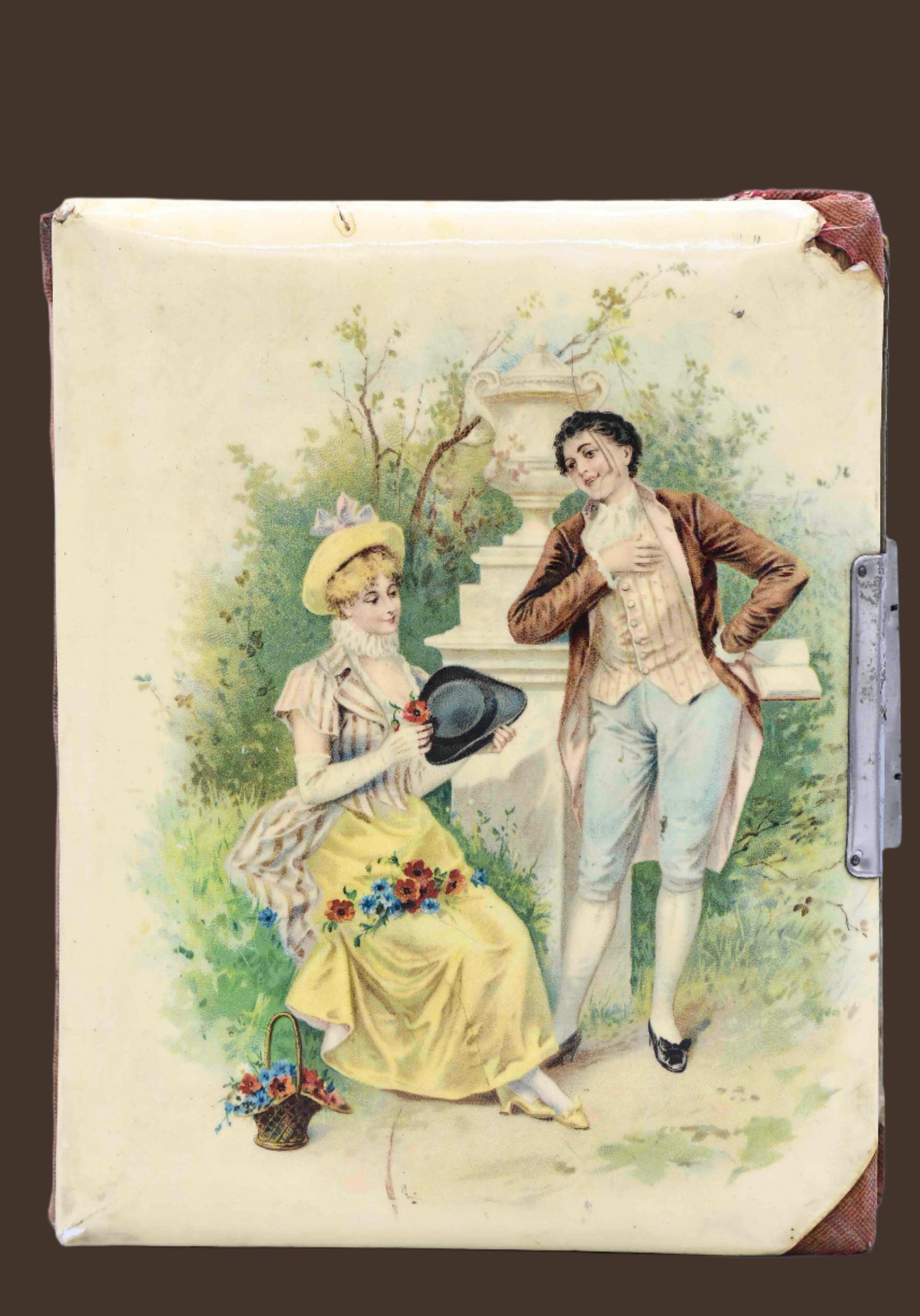Antique photo album cover with English country Victorian style illustration, featuring green leaves and red flowers, with a man and woman in historical clothing.