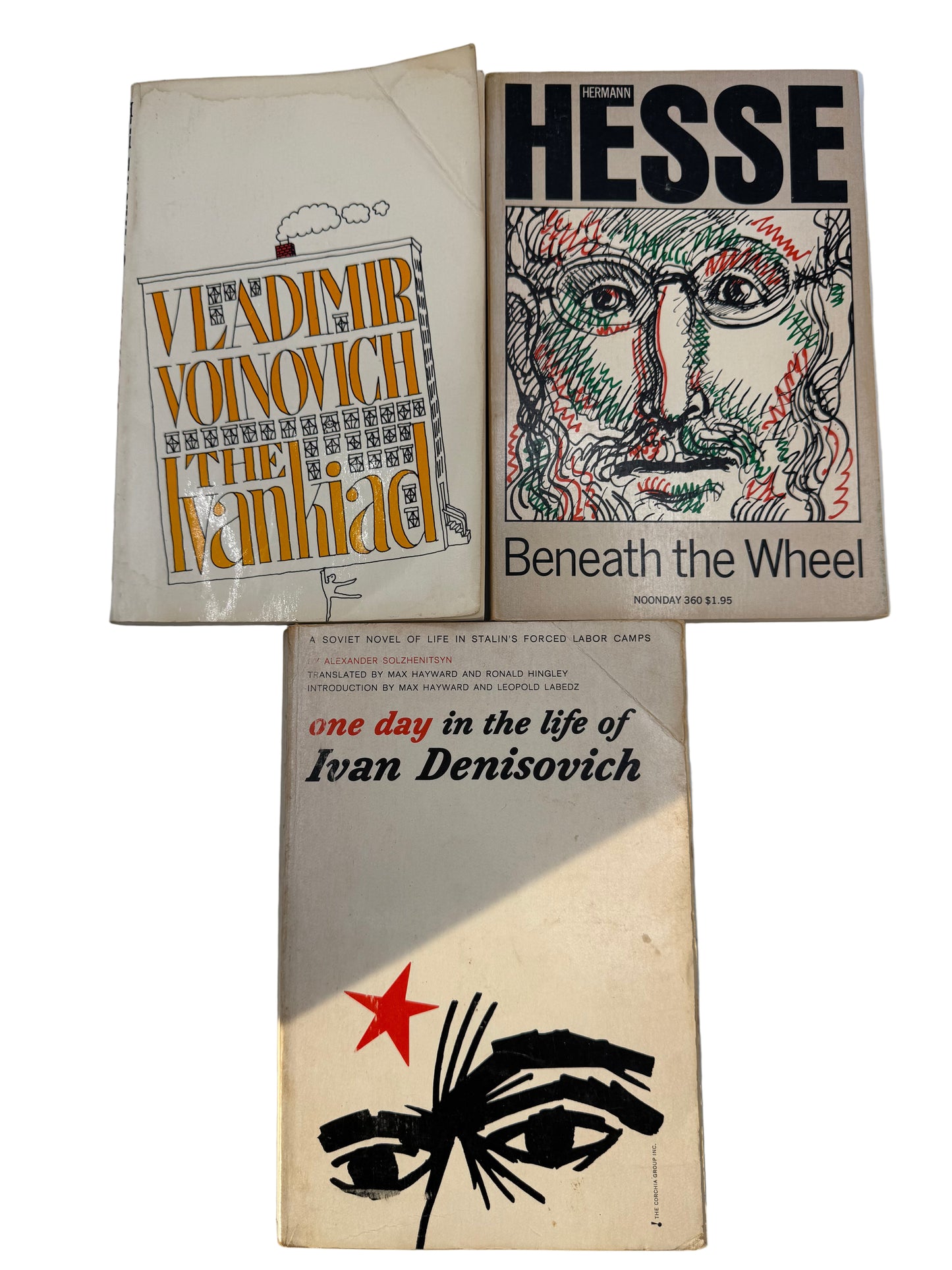 Three books on a white surface with visible titles and covers.