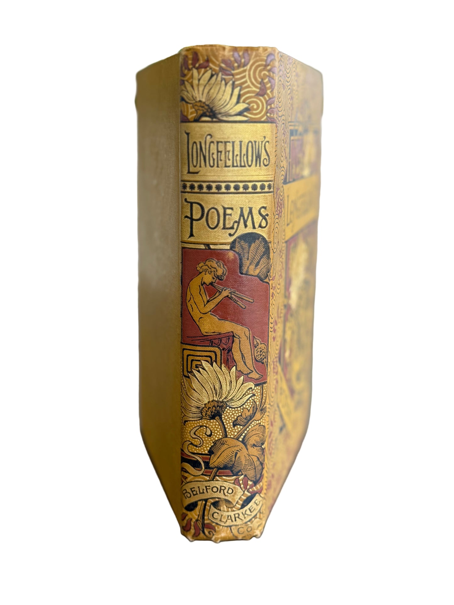 Vintage book titled 'Longfellow's Poems' with decorative cover on a wooden surface.