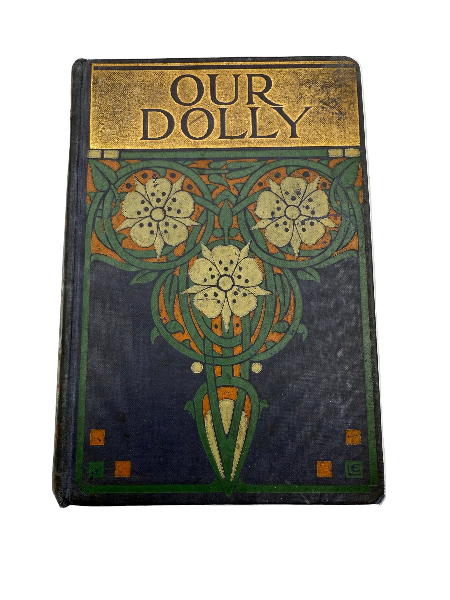 Vintage book titled 'Our Dolly' with decorative cover on a white background