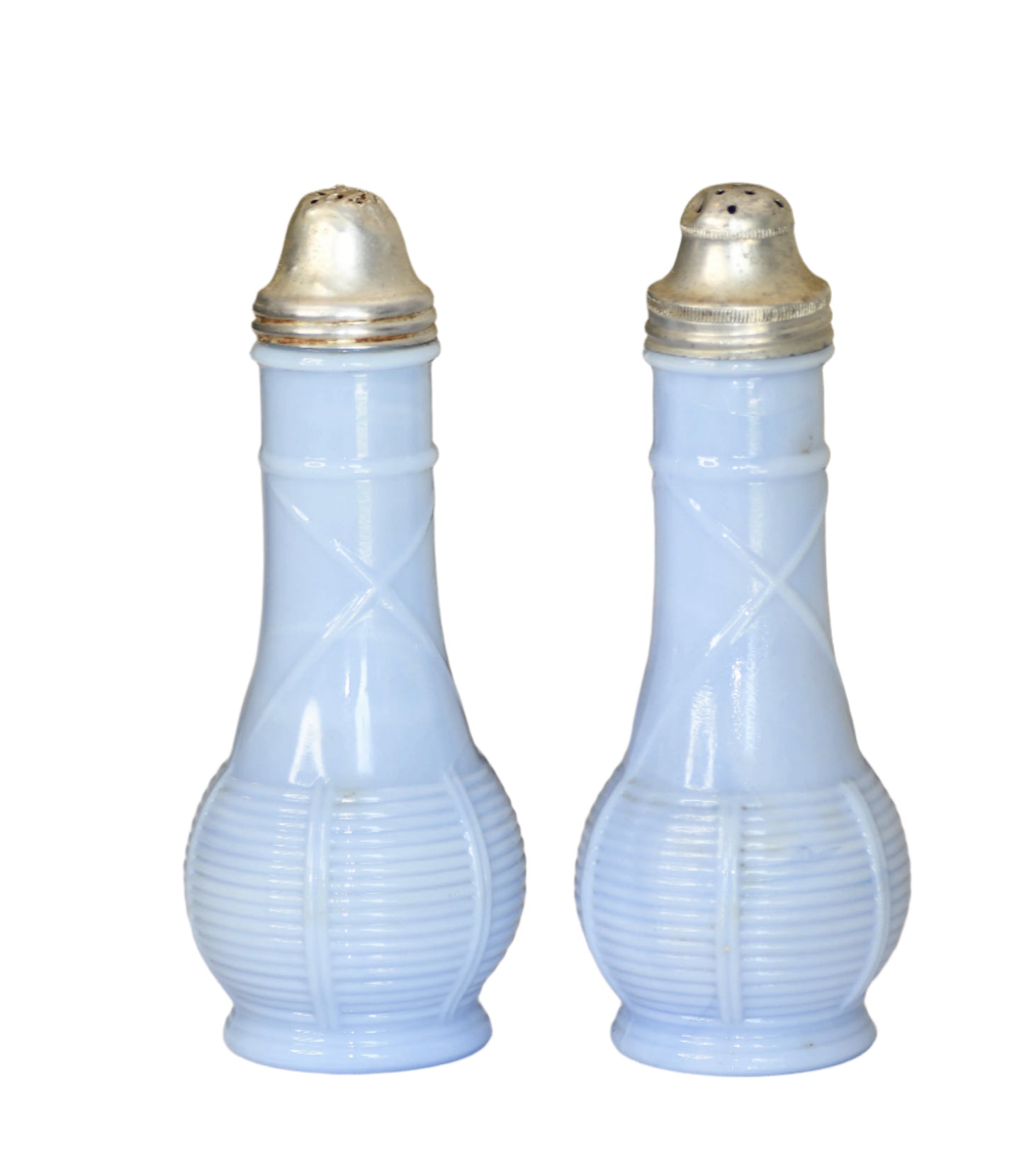 Two light blue glass salt and pepper shakers with gold lids on a neutral background.