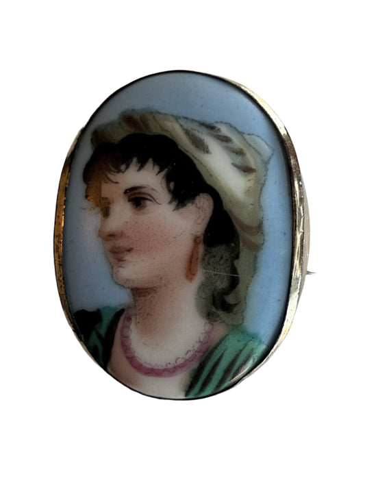 Vintage brooch with a portrait of a woman on an oval background