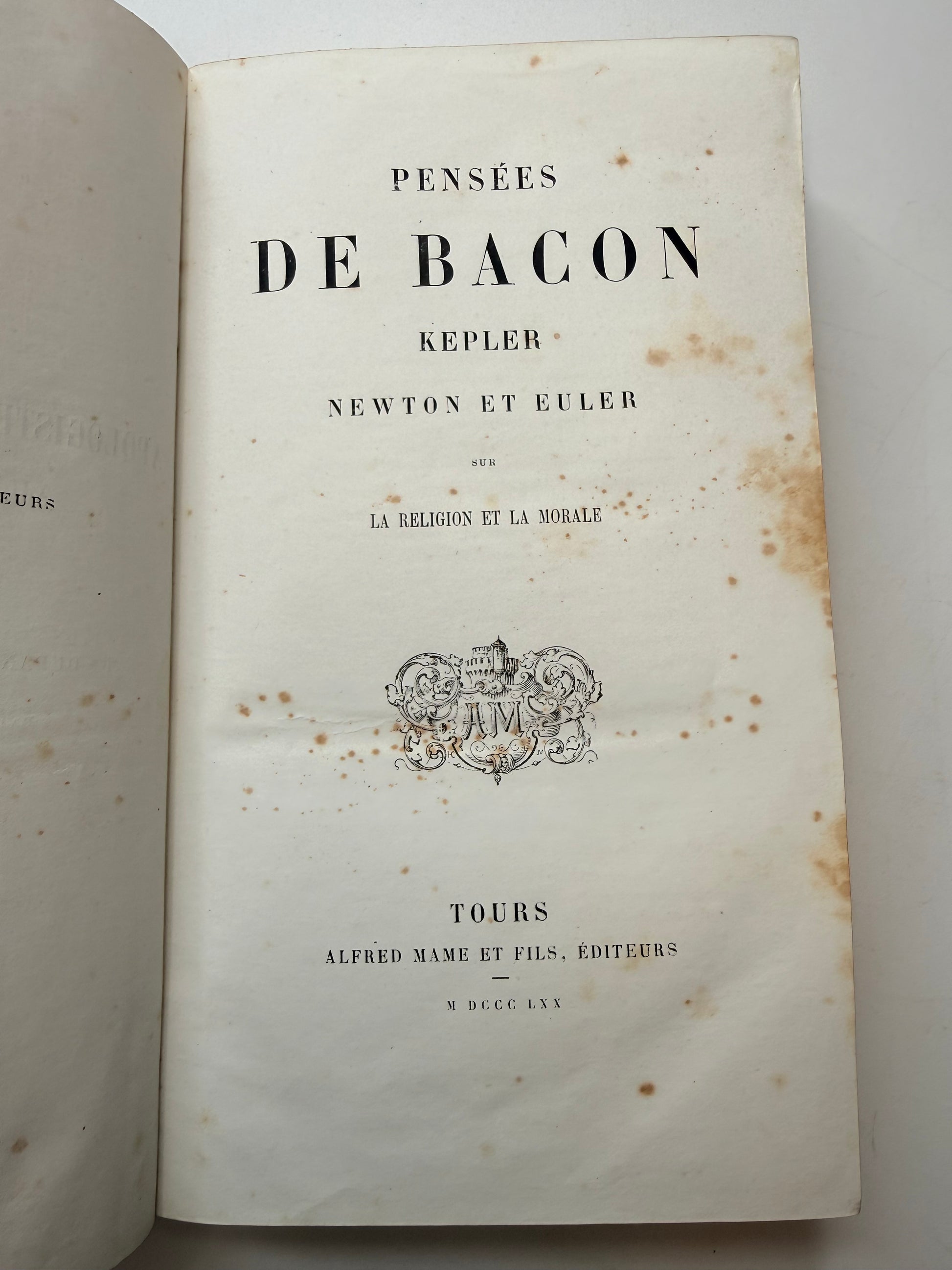 Open book with text and a logo on a white background