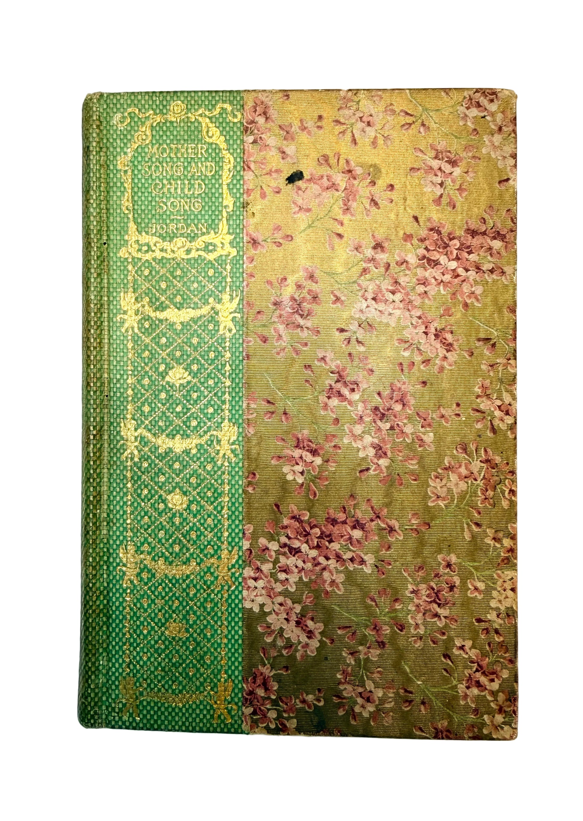 Vintage book with green decorative spine and floral patterned cover on a white background