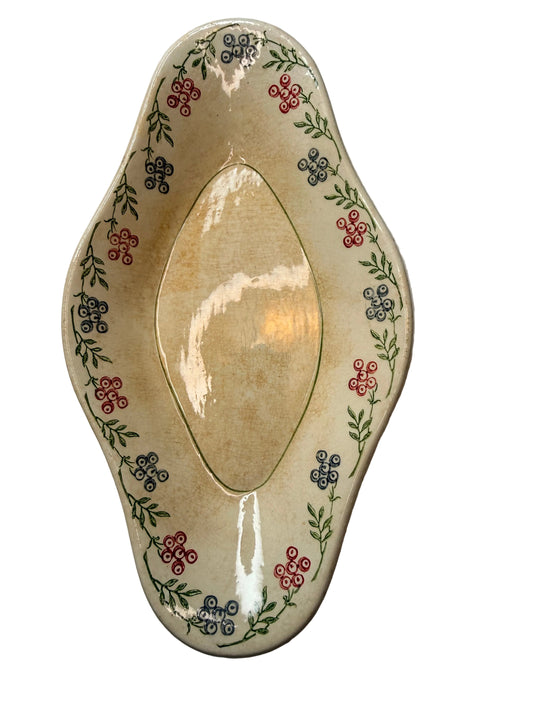 Decorative ceramic plate with floral patterns on a plain background