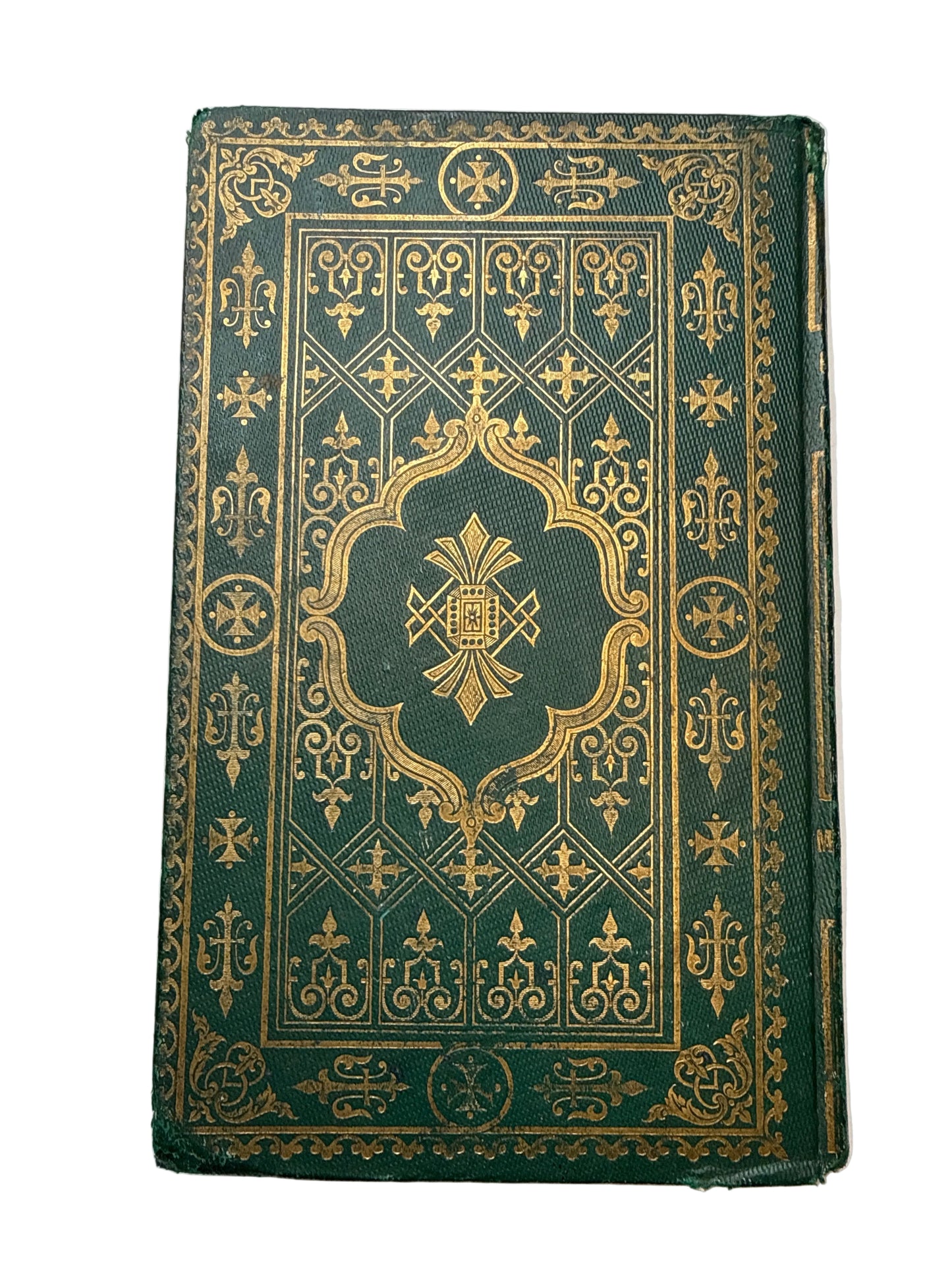 Decorative green book with gold patterns on a white background