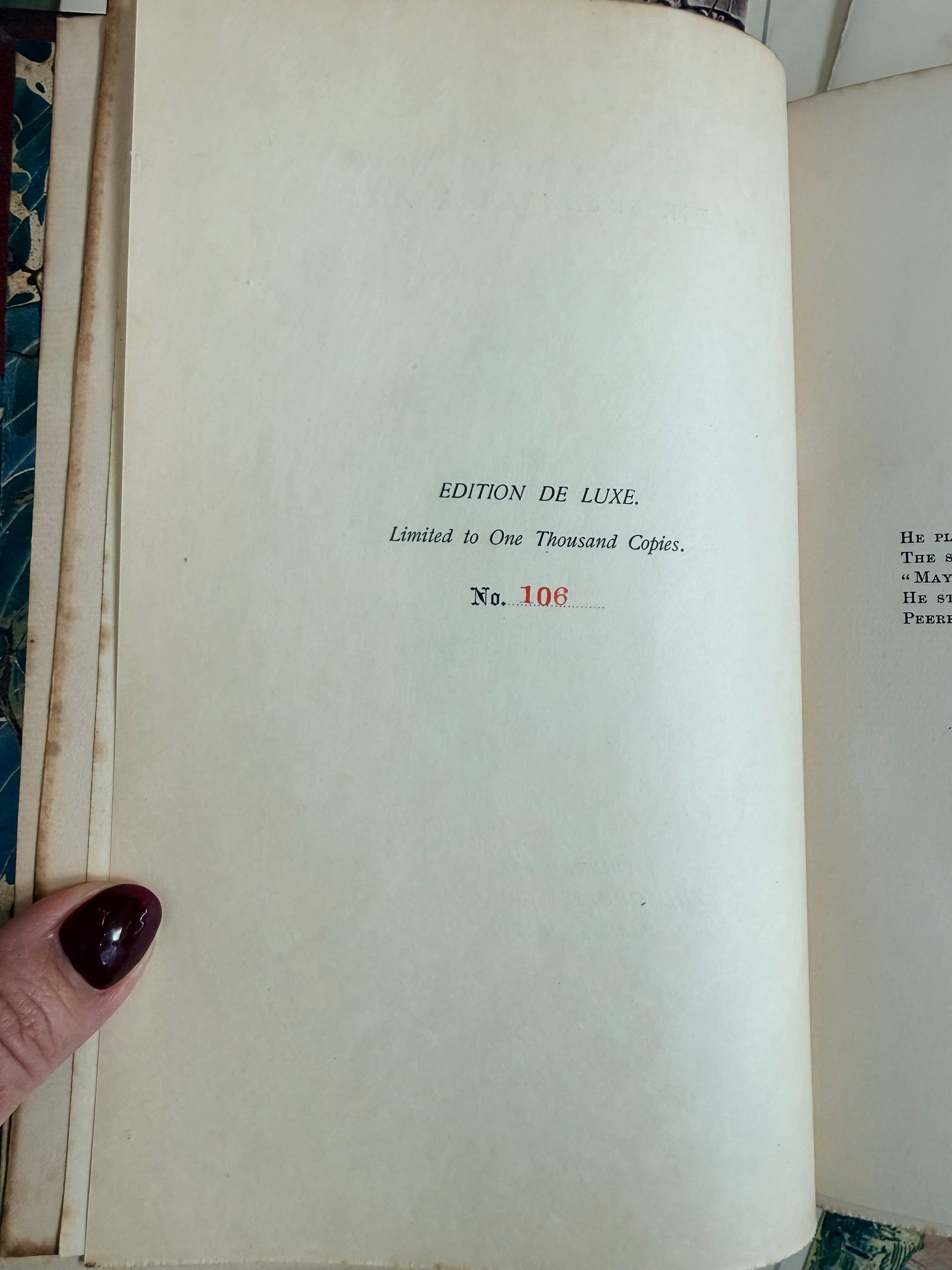 Book page with 'Edition de Luxe' and limited edition number '106” printed on it.