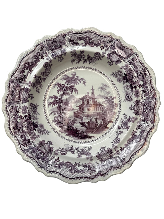 Decorative purple floral plate on a white background