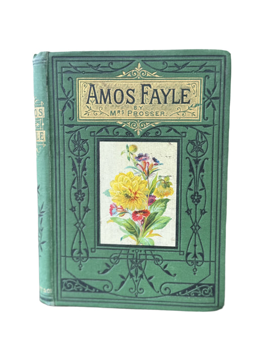 Vintage book titled 'Amos Fayle' with floral illustration on a wooden surface