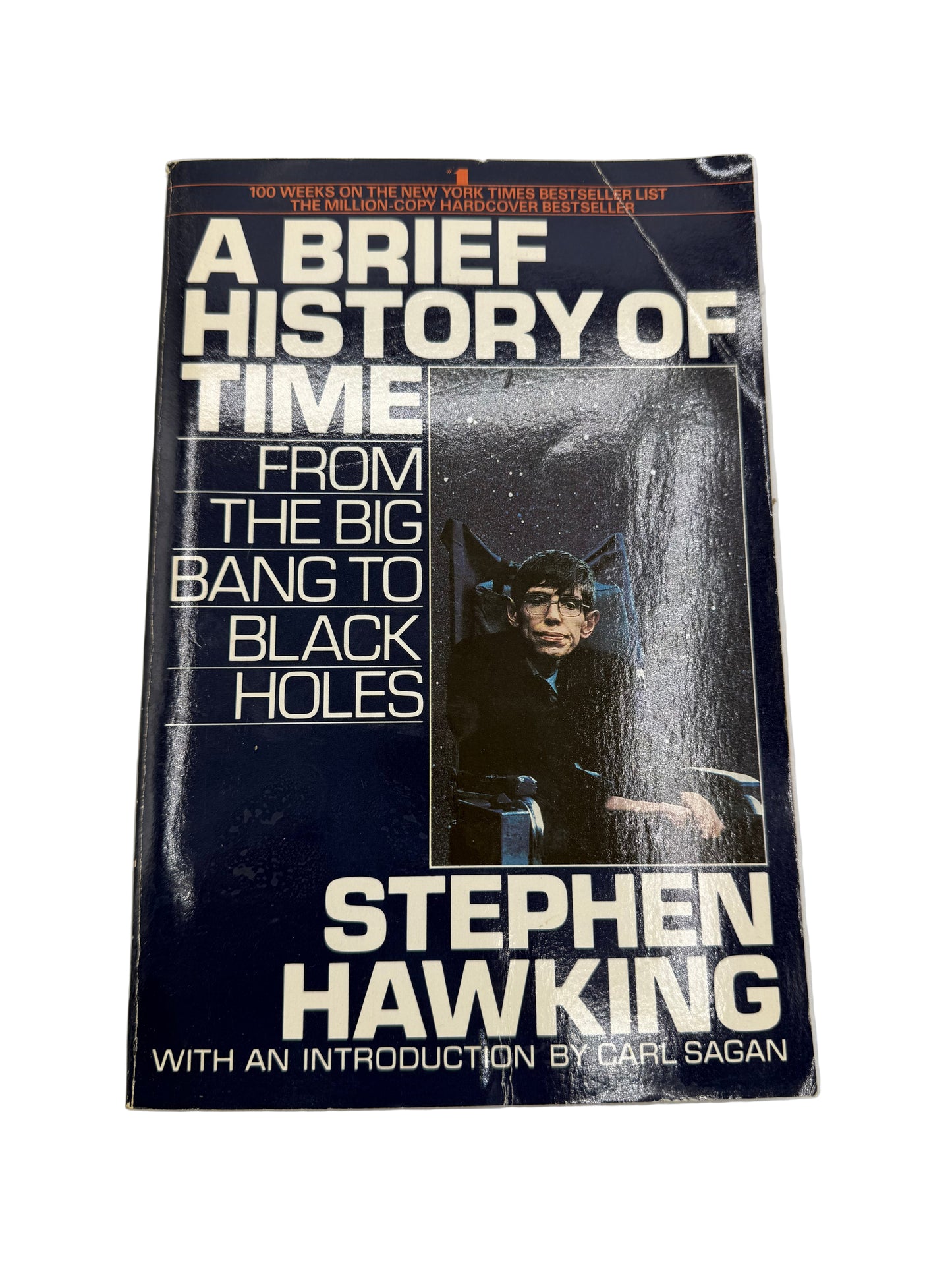 Book titled 'A Brief History of Time' by Stephen Hawking on a light gray background