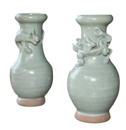 Two ceramic vases with decorative elements on a white background