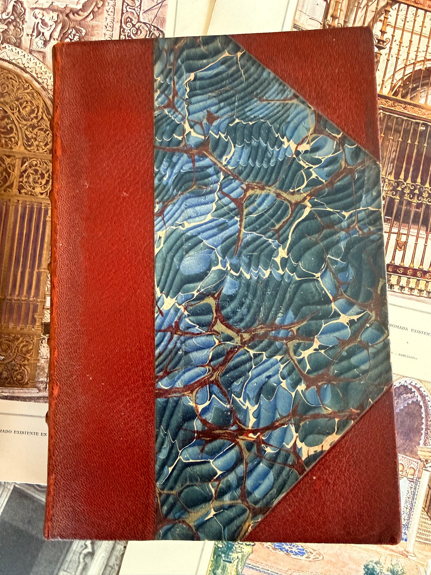 Book with blue and brown marbled design on a red background