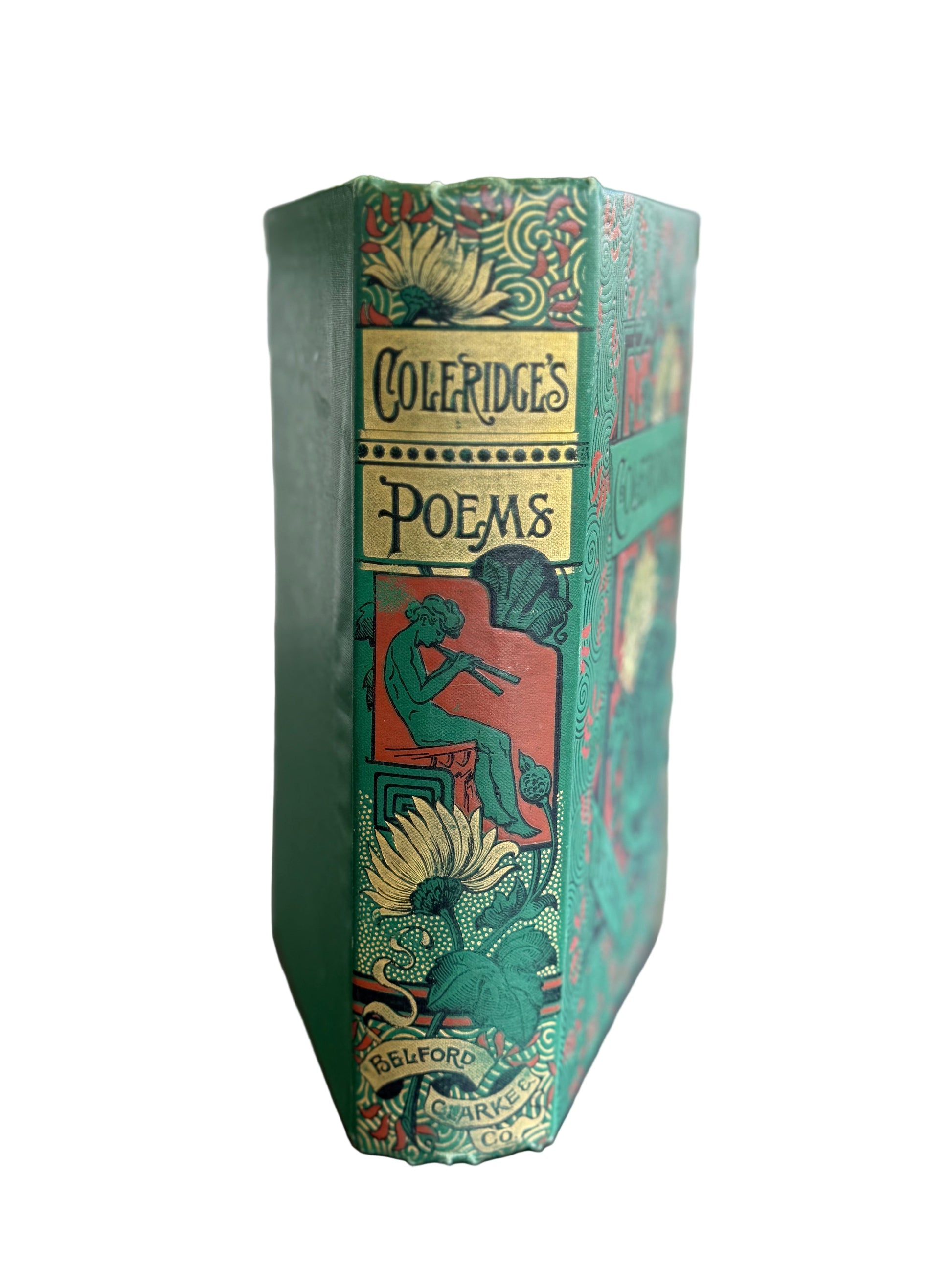 Decorative book titled 'Coleridge's Poems' on a wooden surface with a blurred natural background