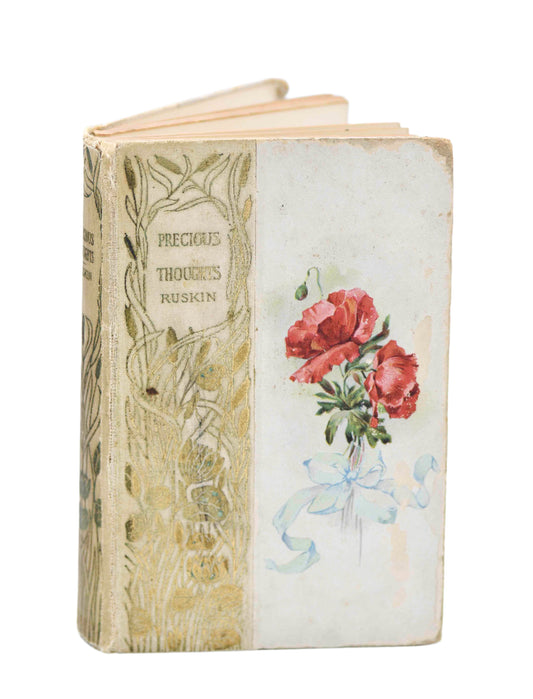 An antique book with a floral edition cover, featuring red carnation decorations and a floral design. The book shows signs of wear such as soiling and a cracked hinge.