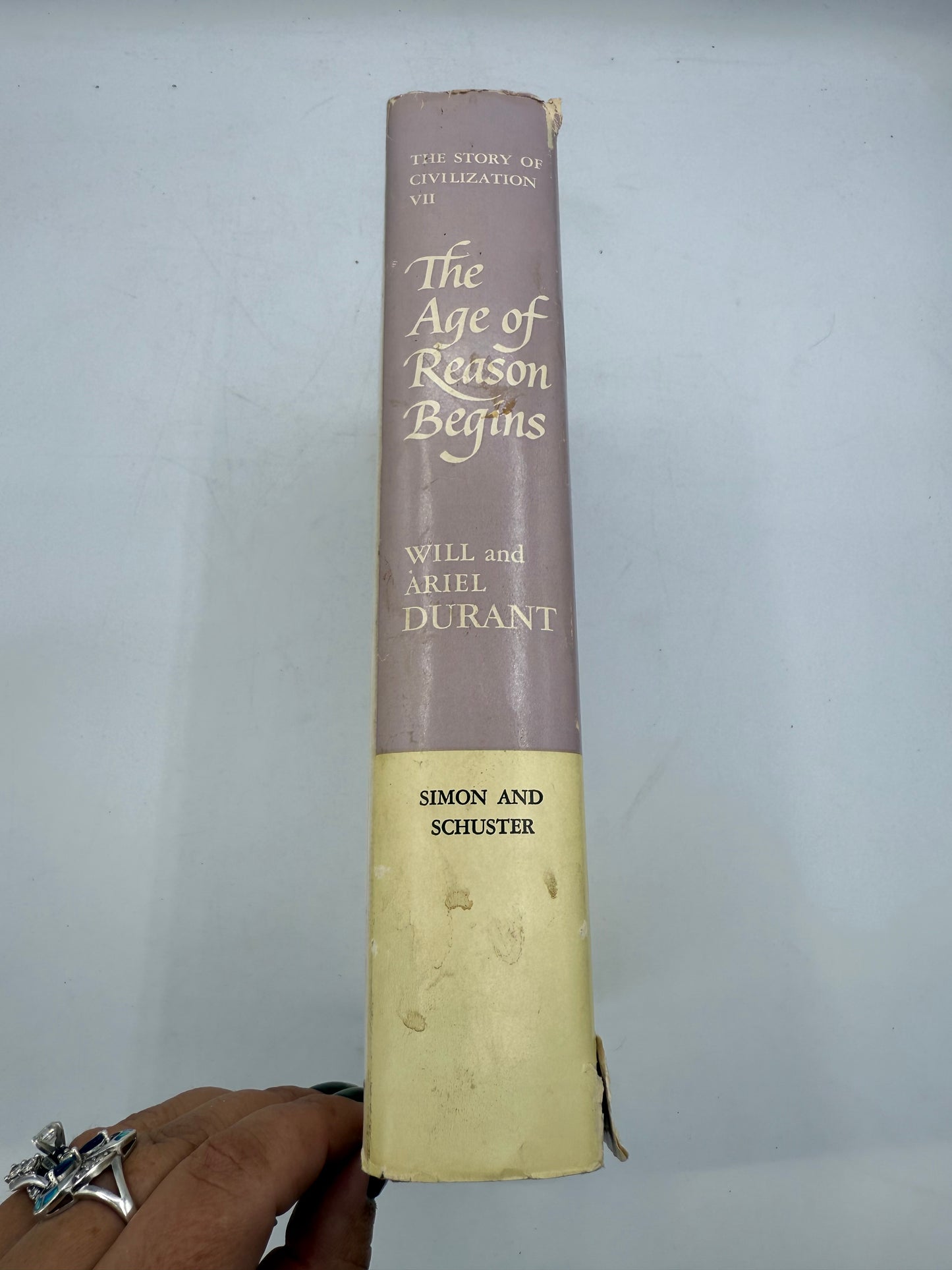 Book titled 'The Age of Reason Begins' by Charles and Aylmer Burdett on a white background