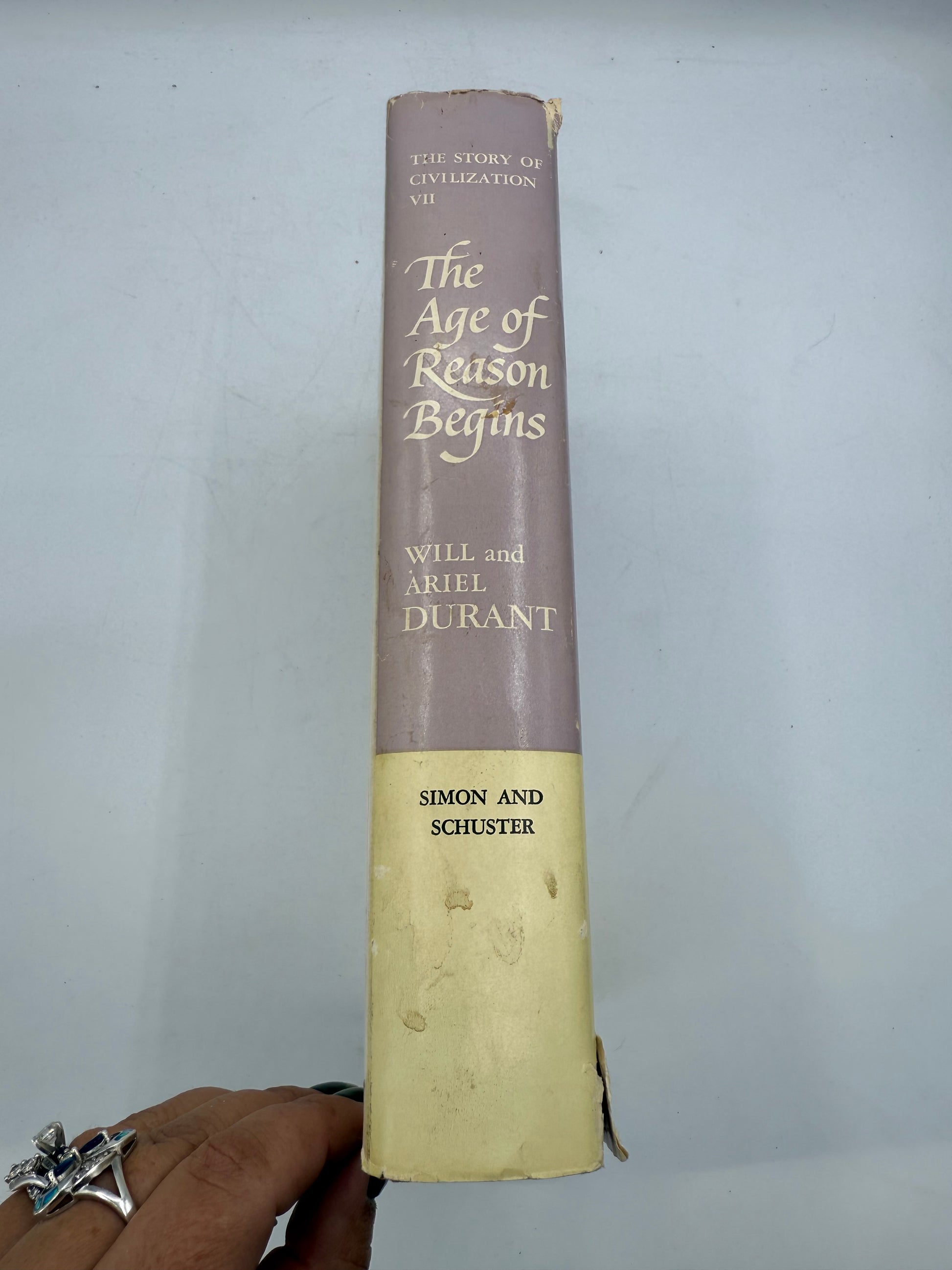 Book titled 'The Age of Reason Begins' by Charles and Aylmer Burdett on a white background