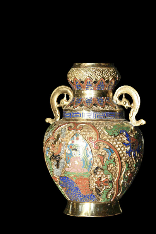 An ornate cloisonne gilded vase with colorful enamel patterns and handles shaped like serpents.
