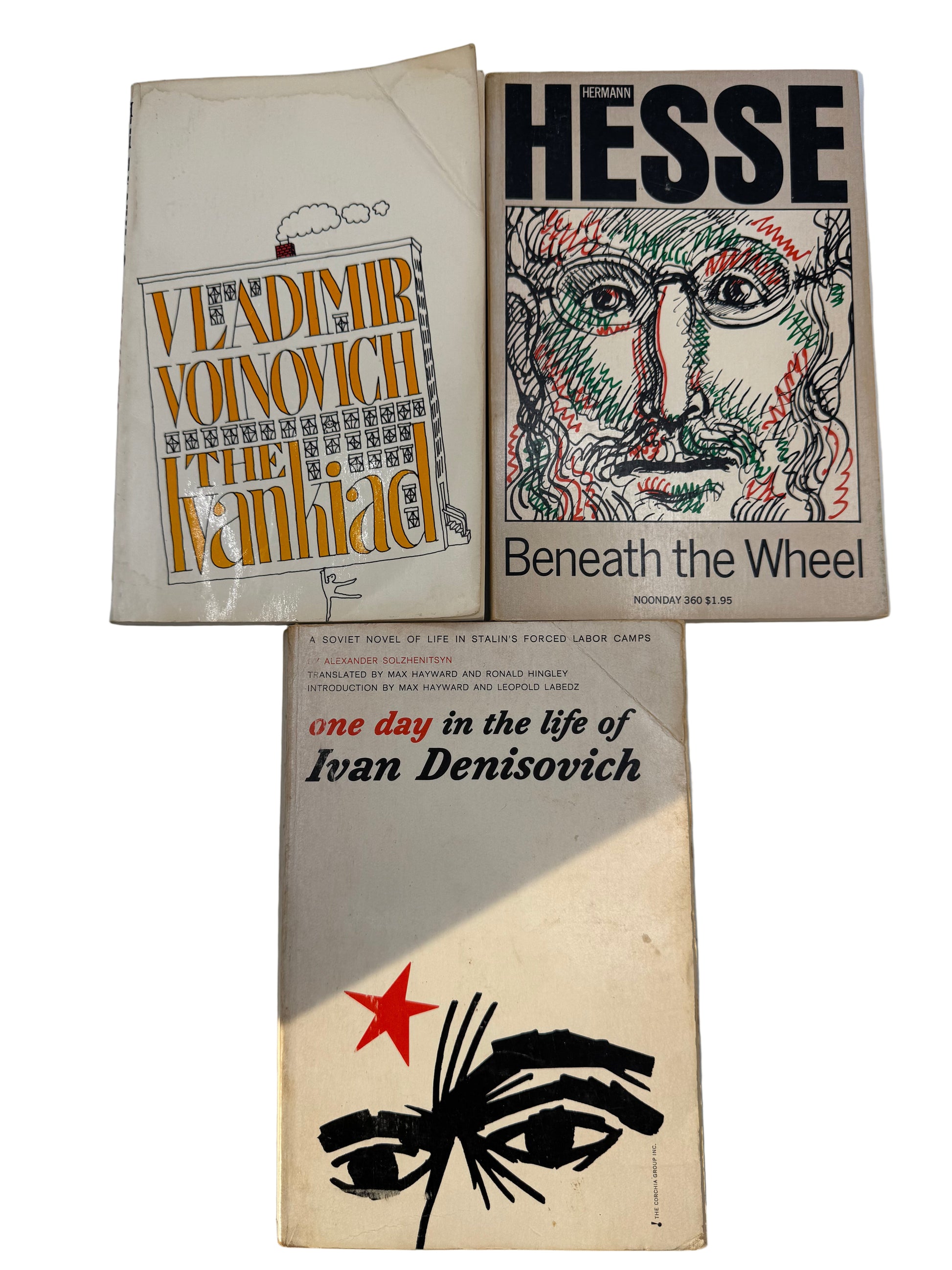 Three books on a white surface with visible titles and covers.