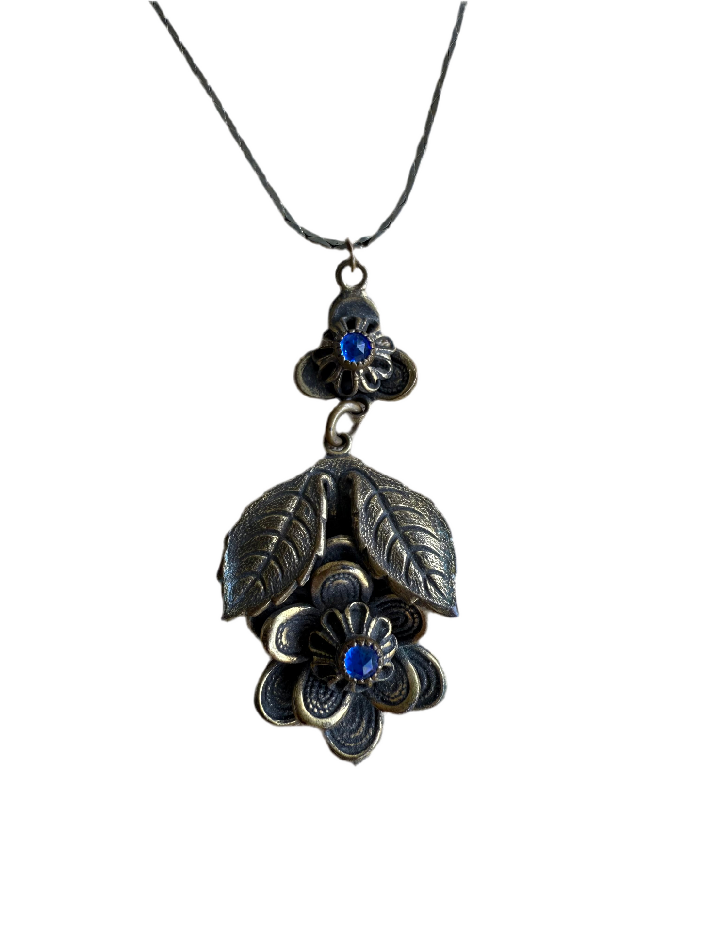 Floral pendant necklace with blue stones on a white background