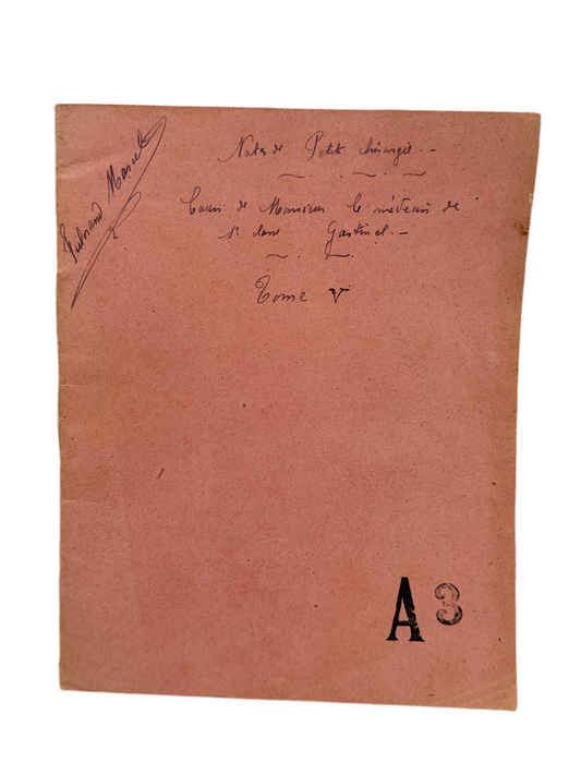 Brown paper sheet with handwritten text and a large 'A' printed on it.
