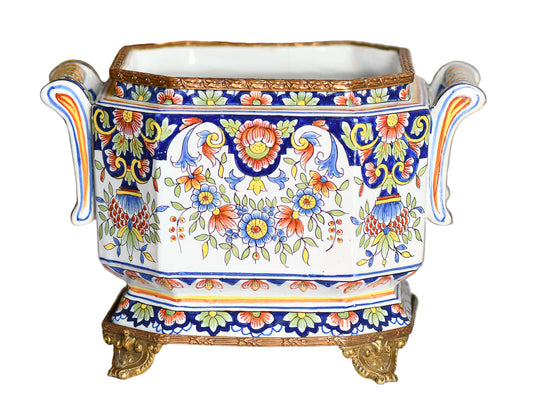 Decorative ceramic Jardiniere Planter with floral patterns on a white surface and gold base