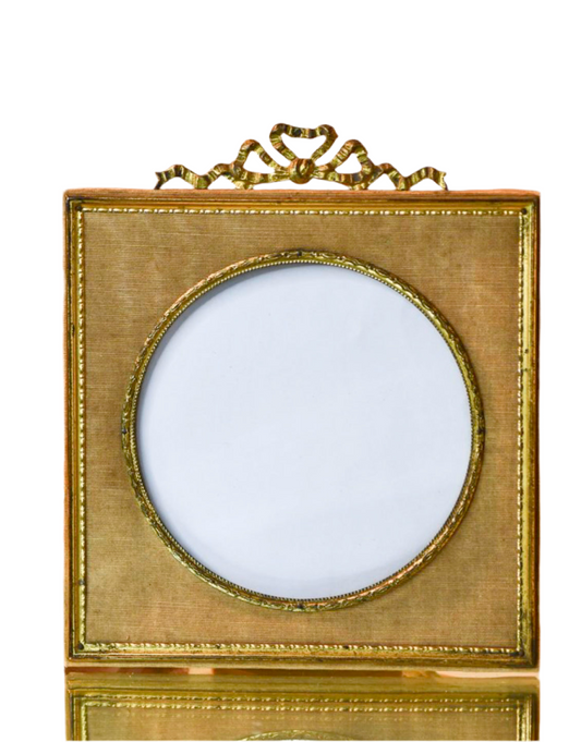 Decorative gold frame with a circular opening on a white background