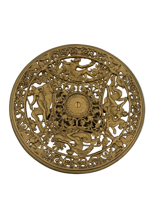 Decorative circular metal object with intricate designs on a white background