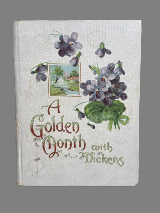 Book titled 'A Golden Month with Dickens' featuring floral designs on the cover.