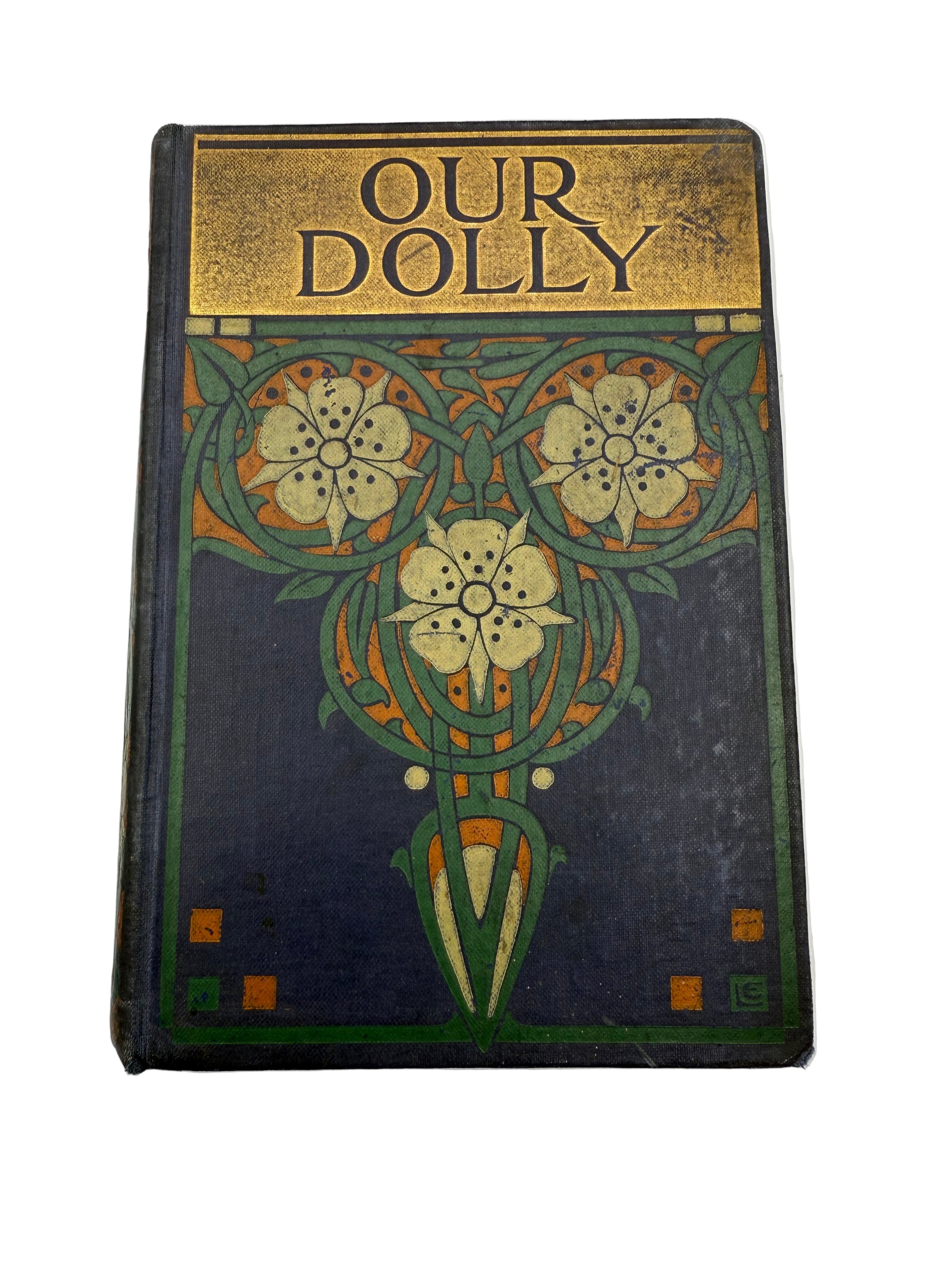 Vintage book titled 'Our Dolly' with decorative cover on a white background