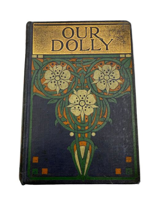 Vintage book titled 'Our Dolly' with decorative cover on a white background