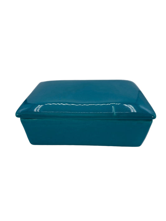 Teal ceramic baking dish with lid on a white background