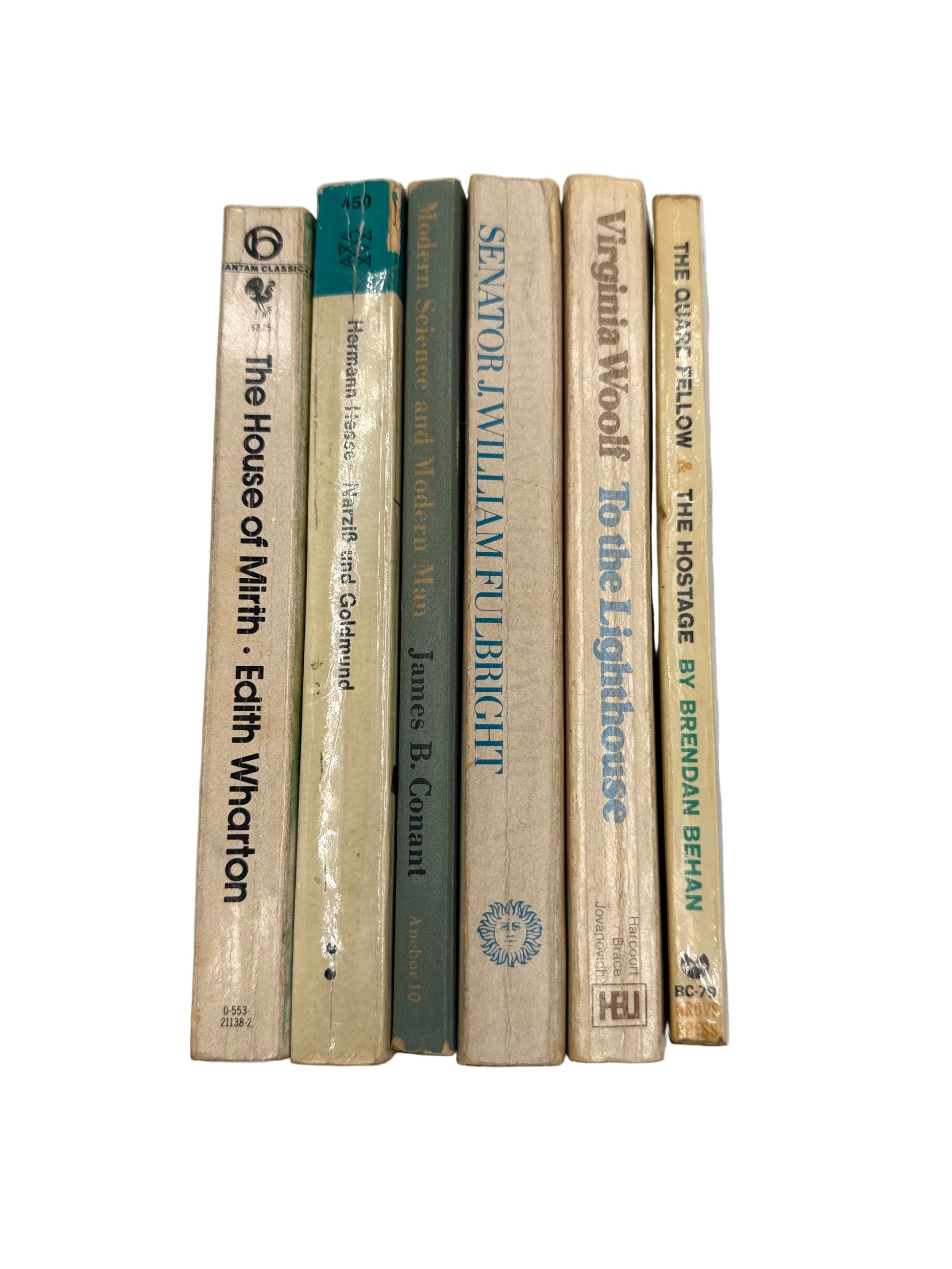 Stack of books held against a plain background