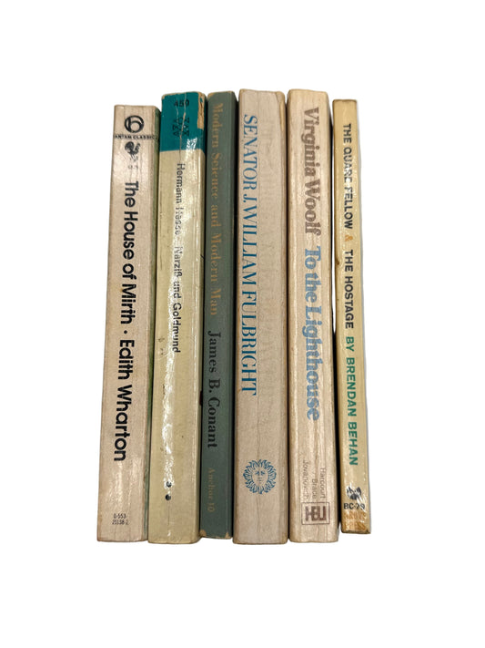 Stack of books held against a plain background