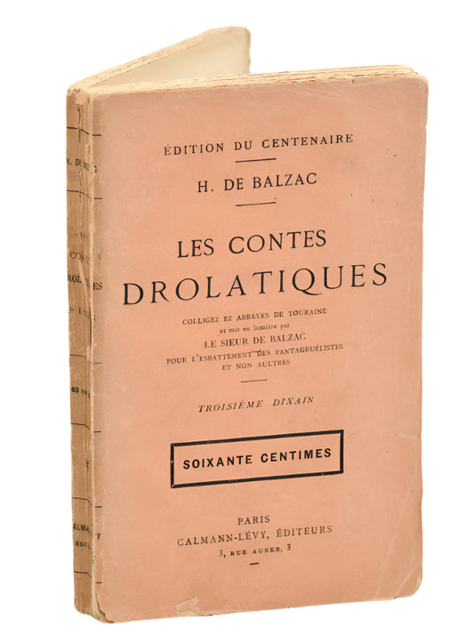 Vintage soft cover book of 'Les Cones Drolatiques' by H. de Balzac with orange cover and pink undertones.